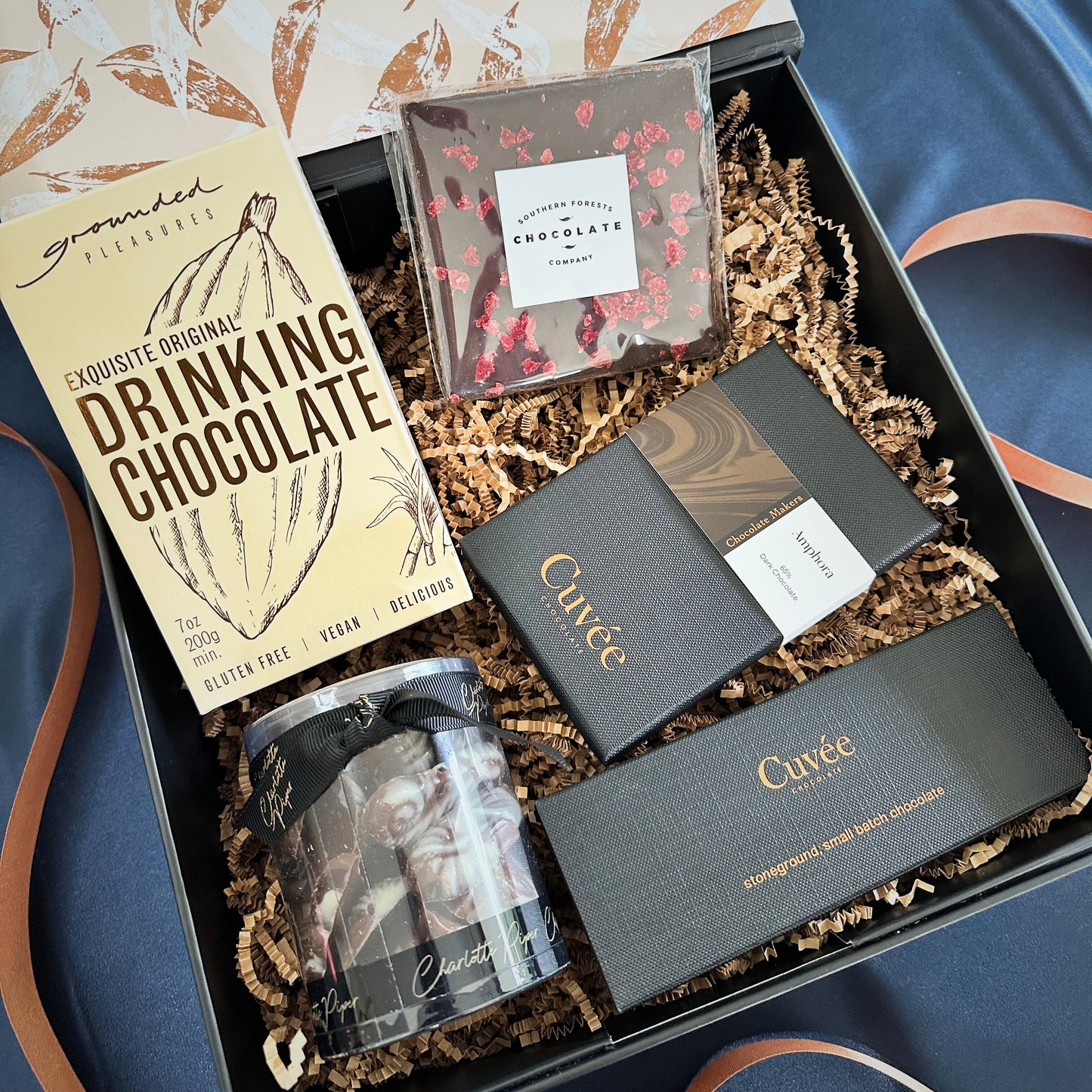 Gift box with Cuvée chocolate bars and other confections on magnetic gift box.