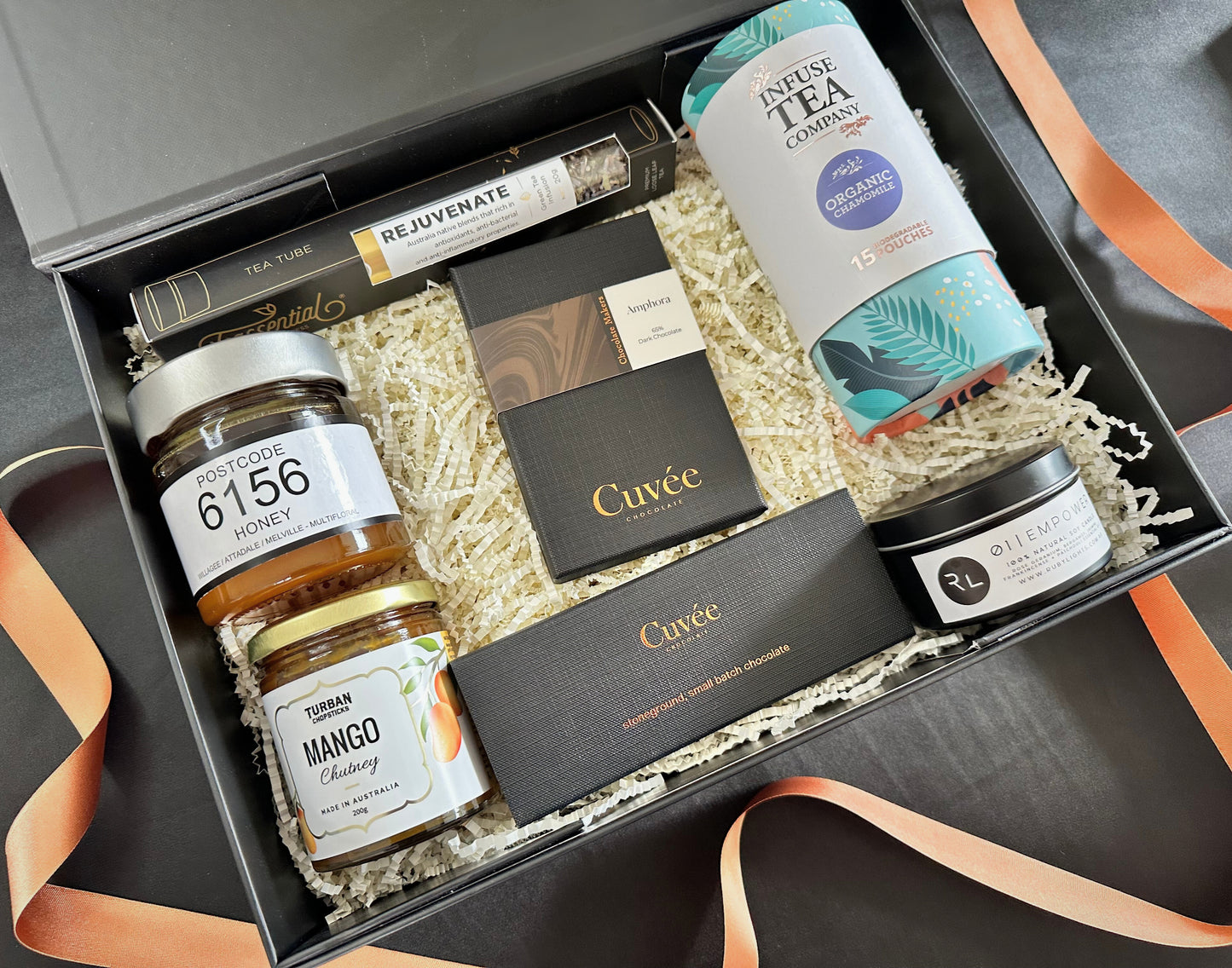 Gift box with various items including honey, tea, and other products.
