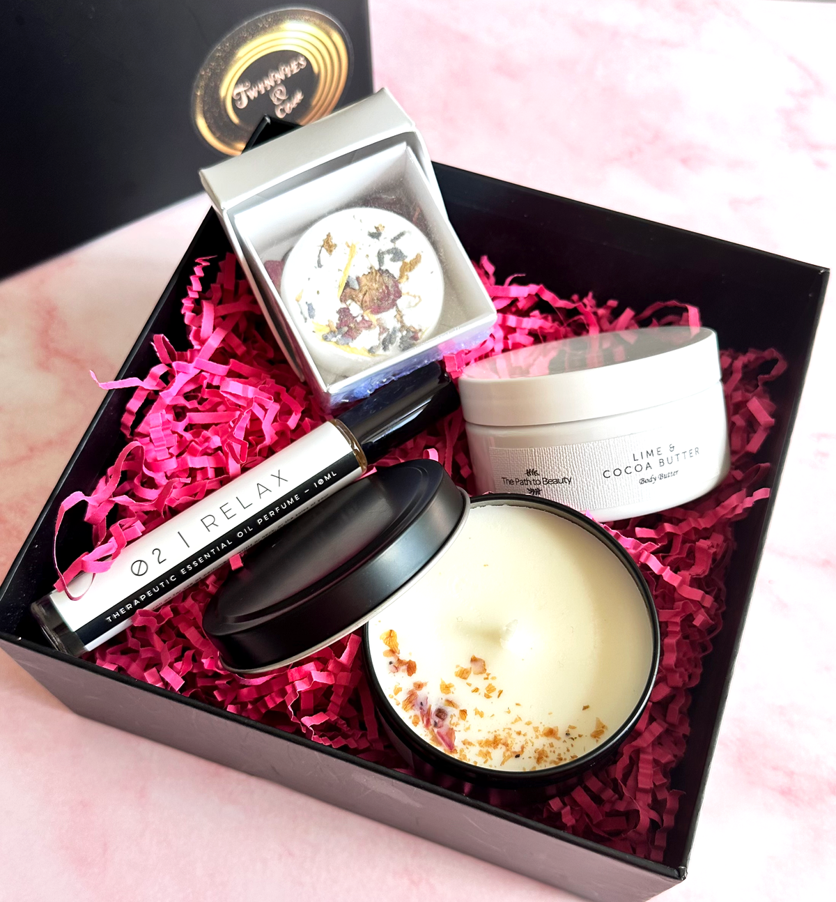 pamper gift box with body butter, shower streamer, candle and essential oil roller perfume