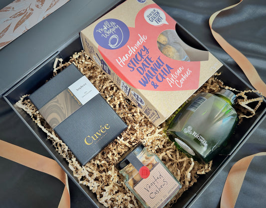 Cheerful Treats Gift Box with chocolate, roasted cashews, fragrance diffuser, and artisan cookies arranged elegantly