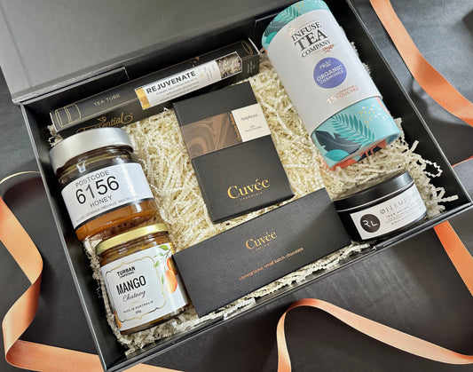 Gift box with various items including honey, tea, and other products.